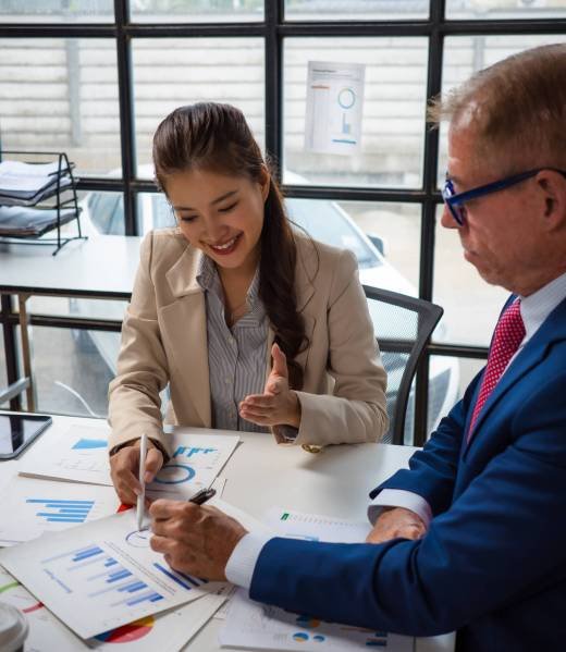 Colleagues collaborating on business data analysis in office meeting
